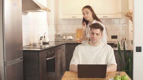 Worried Couple Paying Bills Online with Laptop at Home