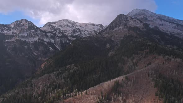 Aerial shot moving slowly away from snow capped mountain peaks