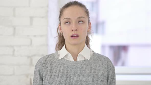 Portrait of Young Latin Woman Crying Looking at the Camera 