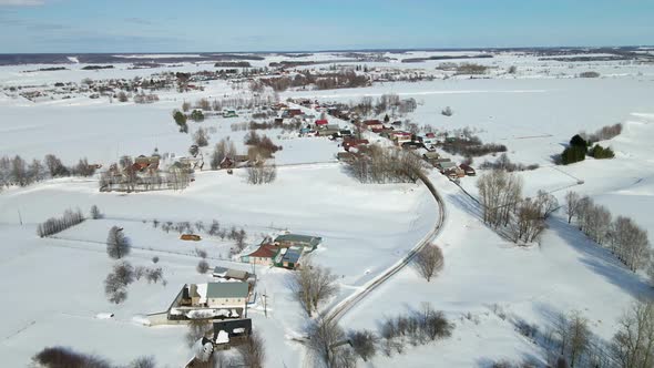 The Drone Flies Over the Village During the Winter Season