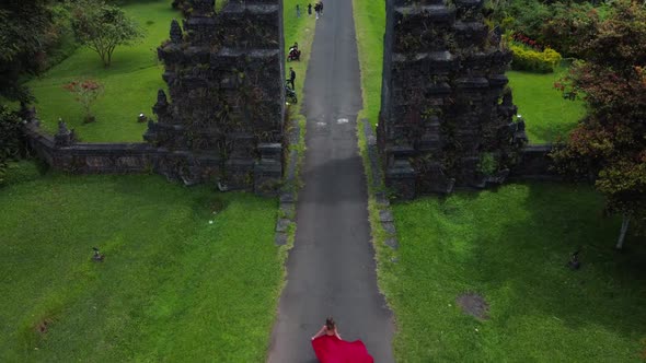 Woman Walks to Balinese Gates in Dress Slowmotion