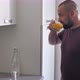 Bearded Man in the Kitchen Drinks Vitamins or Orange Juice - VideoHive Item for Sale