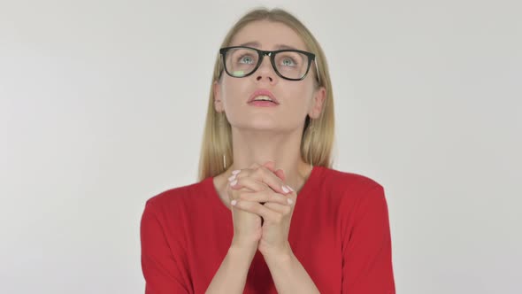 Young Woman Praying with Folded Hands on White Background