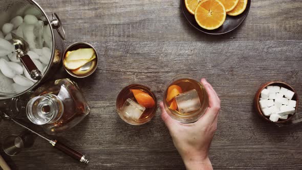 Bourbon old fashioned cocktail garnished with orange peel.