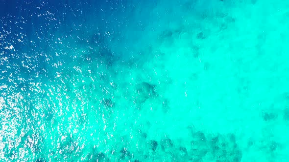 Wide angle birds eye tourism shot of a summer white paradise sand beach and aqua blue water