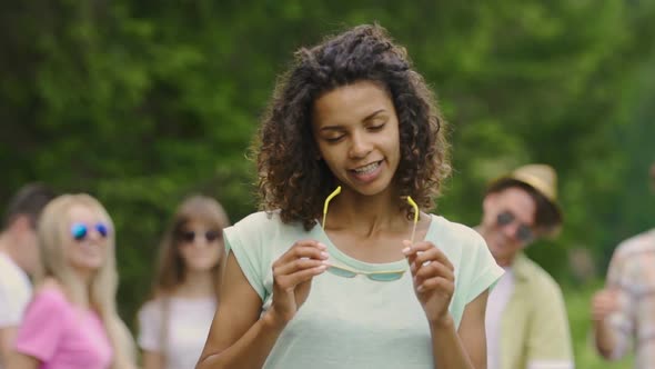 Dreamy Girl With Curly Hair Putting Sunglasses On, Flirting With Camera, Dancing