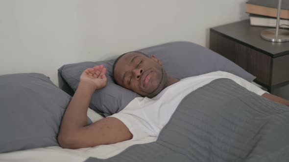 African Man Sleeping in Bed Peacefully