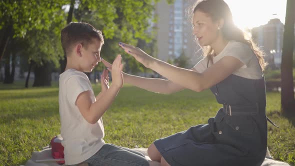 Older Sister Spending Time with Younger Brother Outdoors