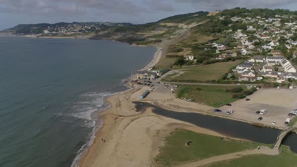 Aerial of Charmouth, Dorset. Facing west, tracking forward and straight. Home of UK fossil hunting.