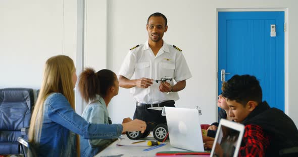 Pilot giving training about drone to kids 