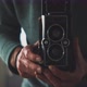 Man holding a medium format vintage camera - VideoHive Item for Sale