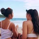 Back of Happy Smiling Beautiful Asian Women in Swimwear Sitting and Laughing on the Tropical Beach - VideoHive Item for Sale