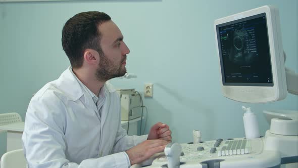 Young Doctor with Ultrasound Diagnostic Machine