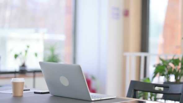 Young Latin Woman Coming Back and Opening Laptop