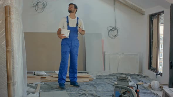 Man As Construction Worker Building House and Carrying Wood