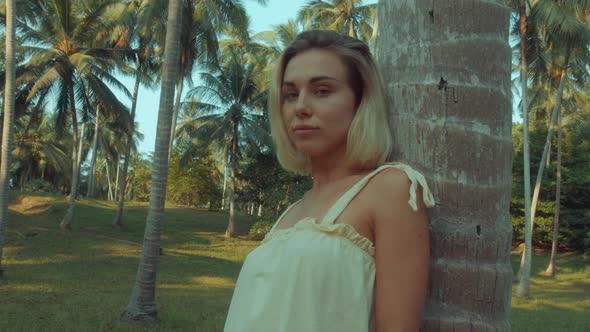 Young Blonde Standing Contemplating Tropical Rainforest Sunset Light Coming From Above