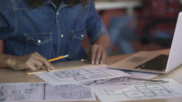 Biracial Female Designer Working on Apartment Layout Plan, Drawing Line on Paper