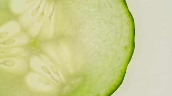 Macro Shot of Transparent Slice of Cucumber Fruit and Rotate