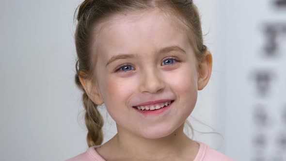 Cheerful Little Girl Smiling on Camera, Childhood Excitement, Happiness Concept