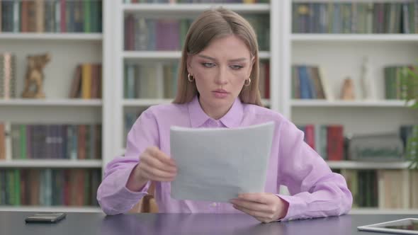 Successful Woman Celebrating While Reading Documents