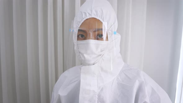 Medical Worker in Full PPE Kit Uniform with Hand Gloves During Covid19 Outbreak Swab Testing Patient