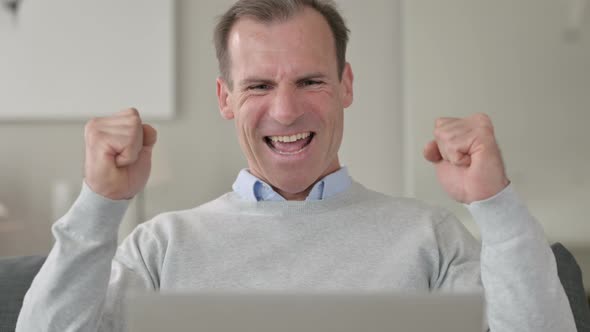 Portrait of Middle Aged Businessman Doing Thumbs Up 