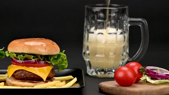 Tasty burgers with french potatoes a mug of beer