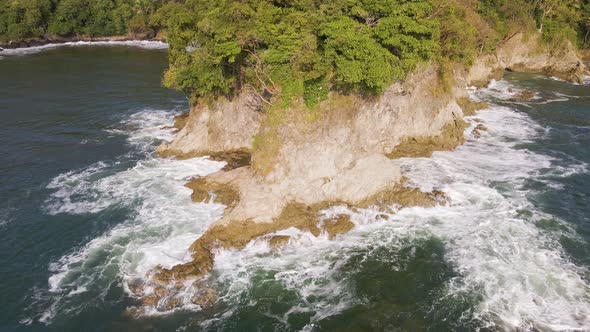 The tip of a secluded peninsula on the central pacific coast of Costa Rica. Aerial descending approa