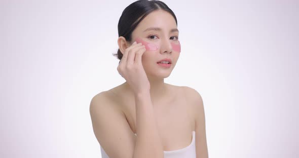 Close Up Beauty Face Asian Woman With Fresh Clean Skin Using Eye Pad.