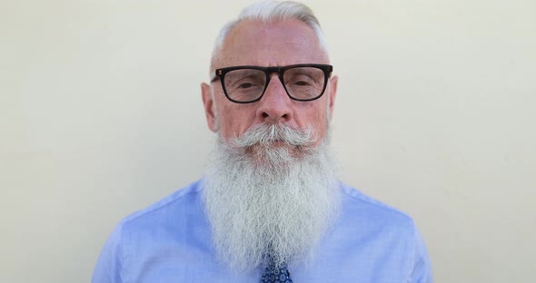 Hipster senior business man looking serious in camera