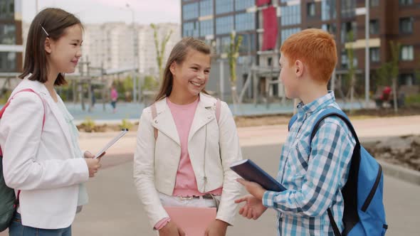 Schoolboy Chatting with Girls Outdoors