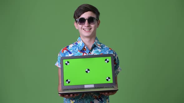 Young Handsome Iranian Teenage Boy Ready for Vacation Against Green Background