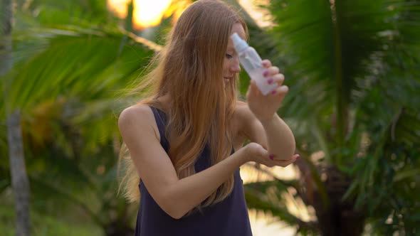 Closeup Shot of a Beautiful Young Woman Applying an Antimosquito Repellent Spray on Her Skin. A