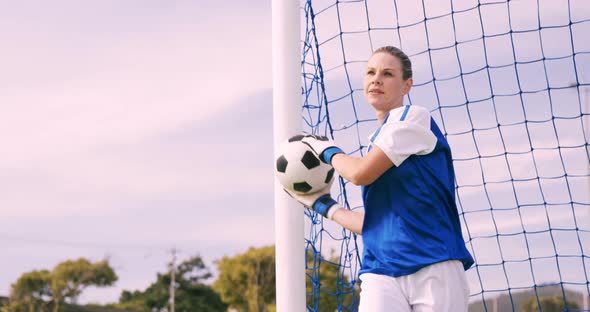 Goalkeeper in blue making a save