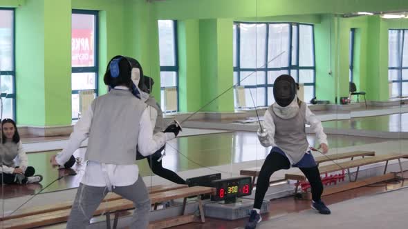 Teenagers practicing fencing at a fencing school