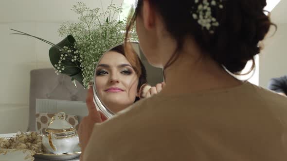 Woman Applying Foundation With Makeup Brush, Mirror View