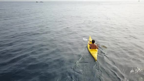 Young man kayaking on the sea