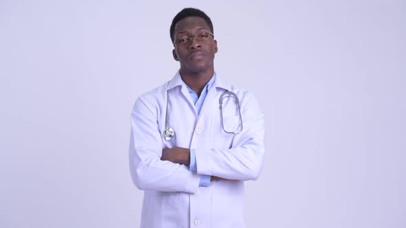 Young Happy African Man Doctor Smiling with Arms Crossed