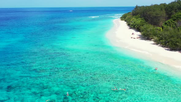 Natural overhead clean view of a white sand paradise beach and aqua blue water background in vibrant