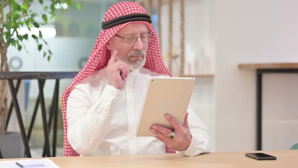 Senior Old Arab Businessman Using Tablet