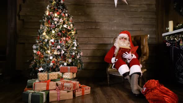 Santa Claus Read Book Near X-mas Tree