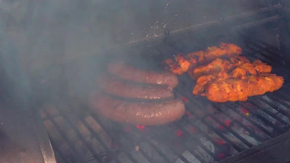 Looking at the Sausages and Chicken Sate getting the heat and smoke of the BBQ