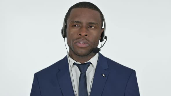 Talking African Businessman with Headset for Call Center, White Background