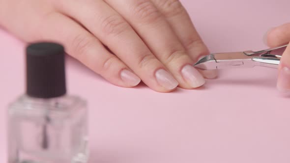 Closeup Woman Hand on Pink Makes Manicure for Herself