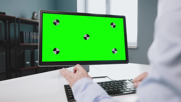 Female Worker Working on Computer with Green Screen