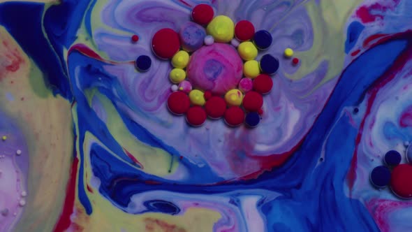 Abstract close up texture of oil with blue, red and yellow paint alt