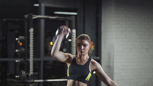 Strong Woman Performs Exercises with Kettlebells Lifts Weights and Does Kettlebell Crossfit Training