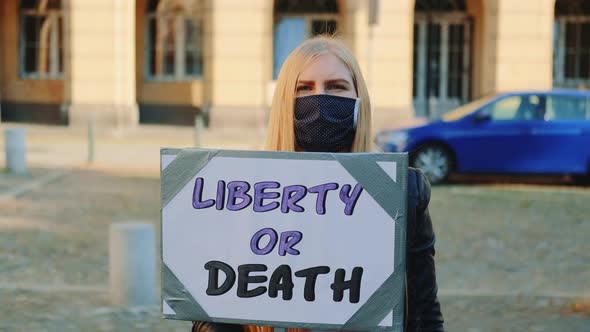 Blonde Woman with Protest Banner Calling To Choose Liberty or Death