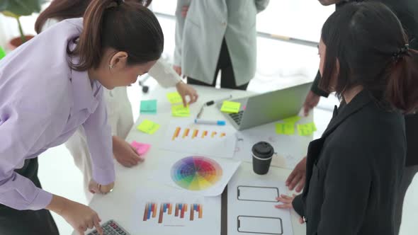 Business People Proficiently Discuss Work Project on Meeting Table