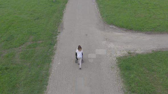 Above mother and baby carriage on the road 4K aerial video